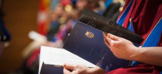 Close up view of an individual holding a UBC congregation brochure
